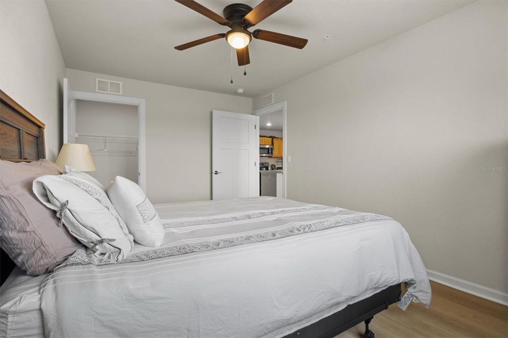 260 Spanish Moss Circle, Unit 101 Sebring, FL 33876 - Photo 12 of 35 a bed room with a bed and a chandelier