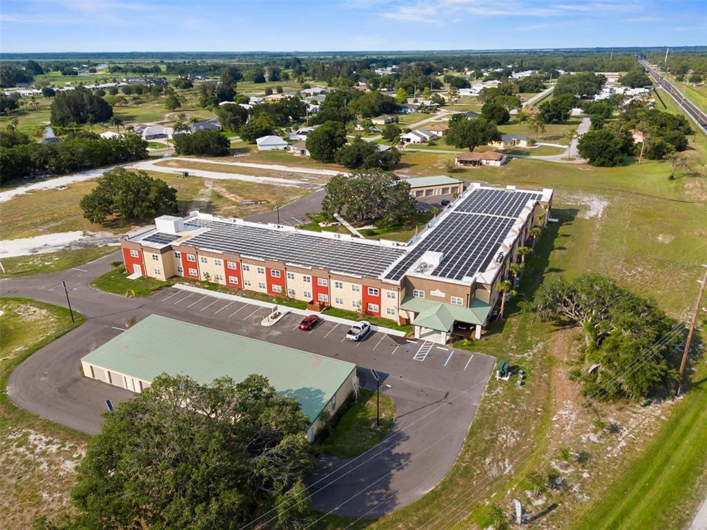 260 Spanish Moss Circle, Unit 101 Sebring, FL 33876 - Photo 18 of 35 an aerial view of a house with a big yard