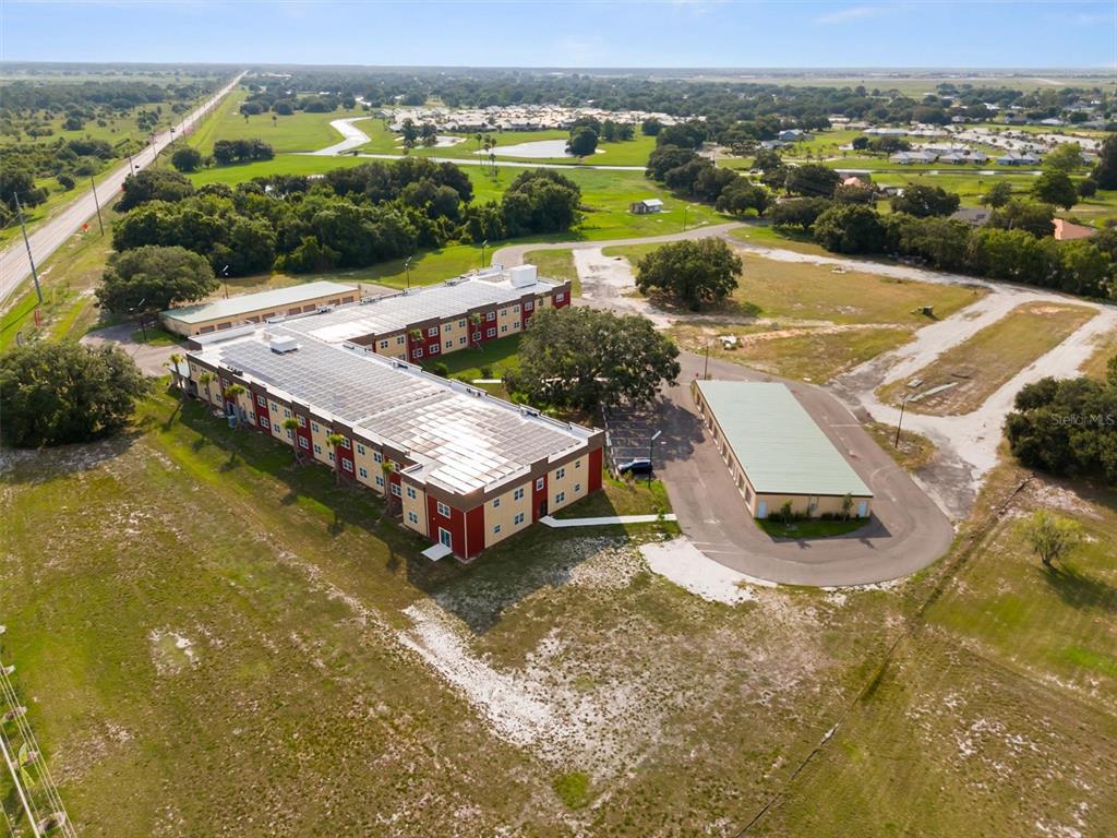 260 Spanish Moss Circle, Unit 101 Sebring, FL 33876 - Photo 19 of 35 an aerial view of a house with a garden and lake view