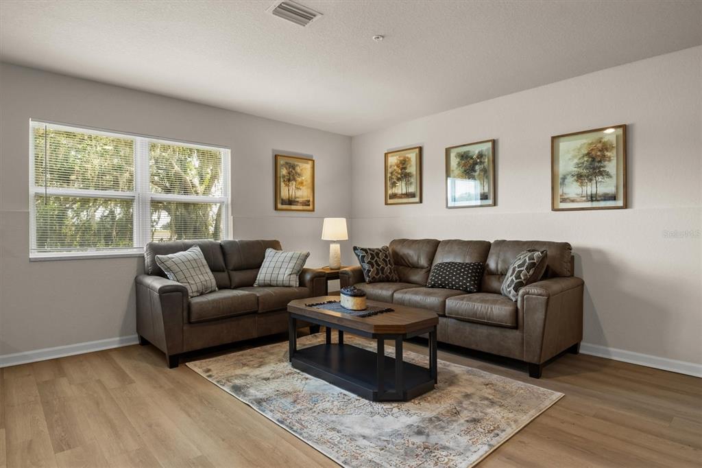 260 Spanish Moss Circle, Unit 101 Sebring, FL 33876 - Photo 34 of 35 a living room with furniture and a window