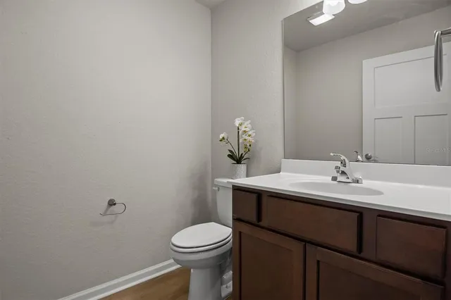 a bathroom with a sink a toilet and mirror