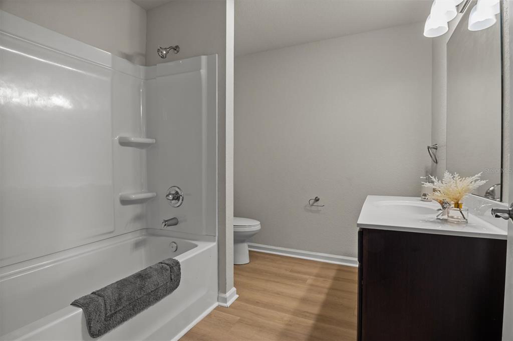 260 Spanish Moss Circle, Unit 101 Sebring, FL 33876 - Photo 10 of 35 a bathroom with a sink a toilet and shower