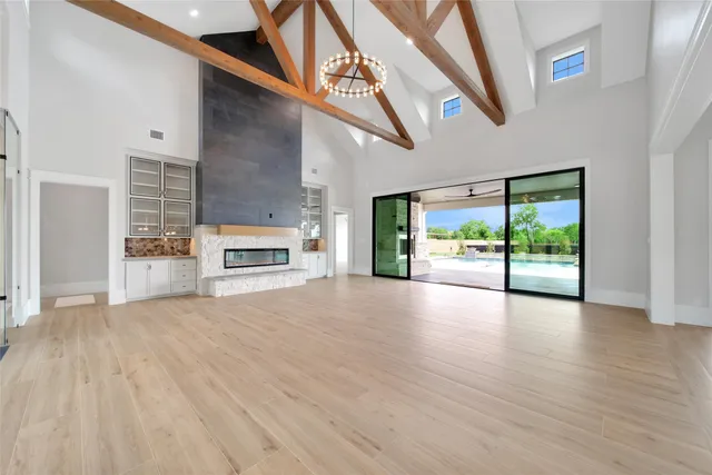 a view of a room with wooden floor a ceiling fan and window