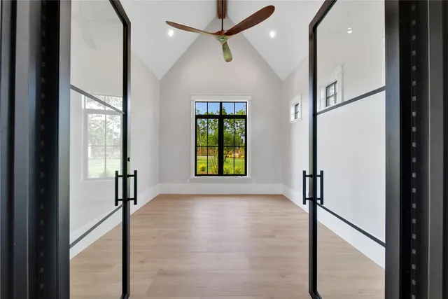 a view of hallway with windows and chandelier