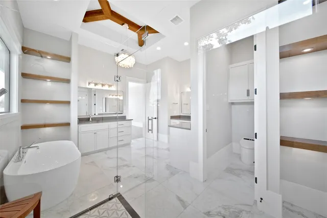 a bathroom with a glass shower door and a sink