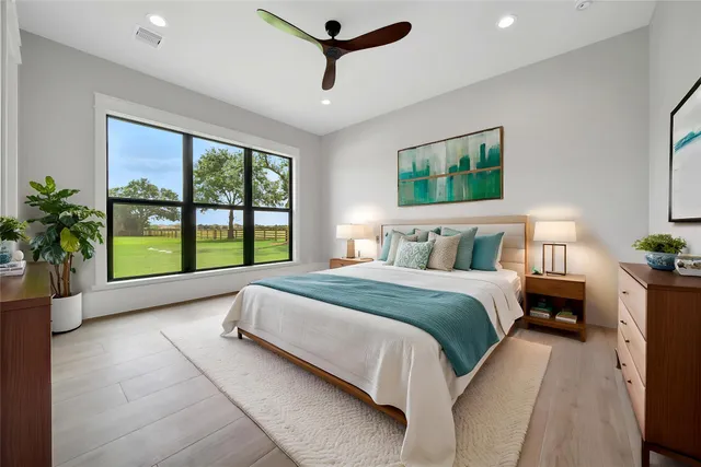 a spacious bedroom with a large bed and a large window