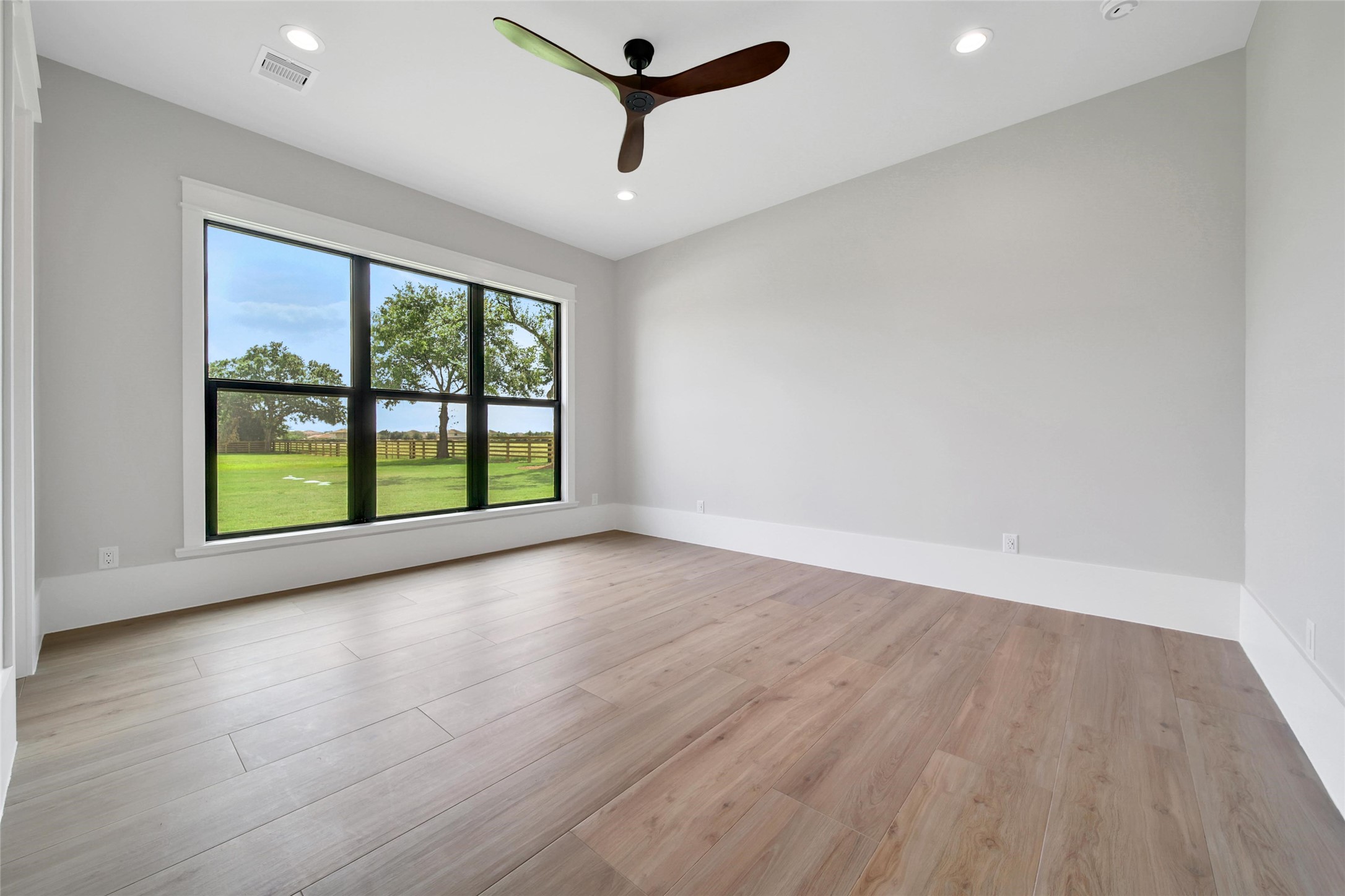 18829 Cypress Church Road Cypress, TX 77433 - Photo 28 of 50 an empty room with wooden floor and windows