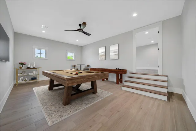 a living room with furniture a wooden floor and potted plant