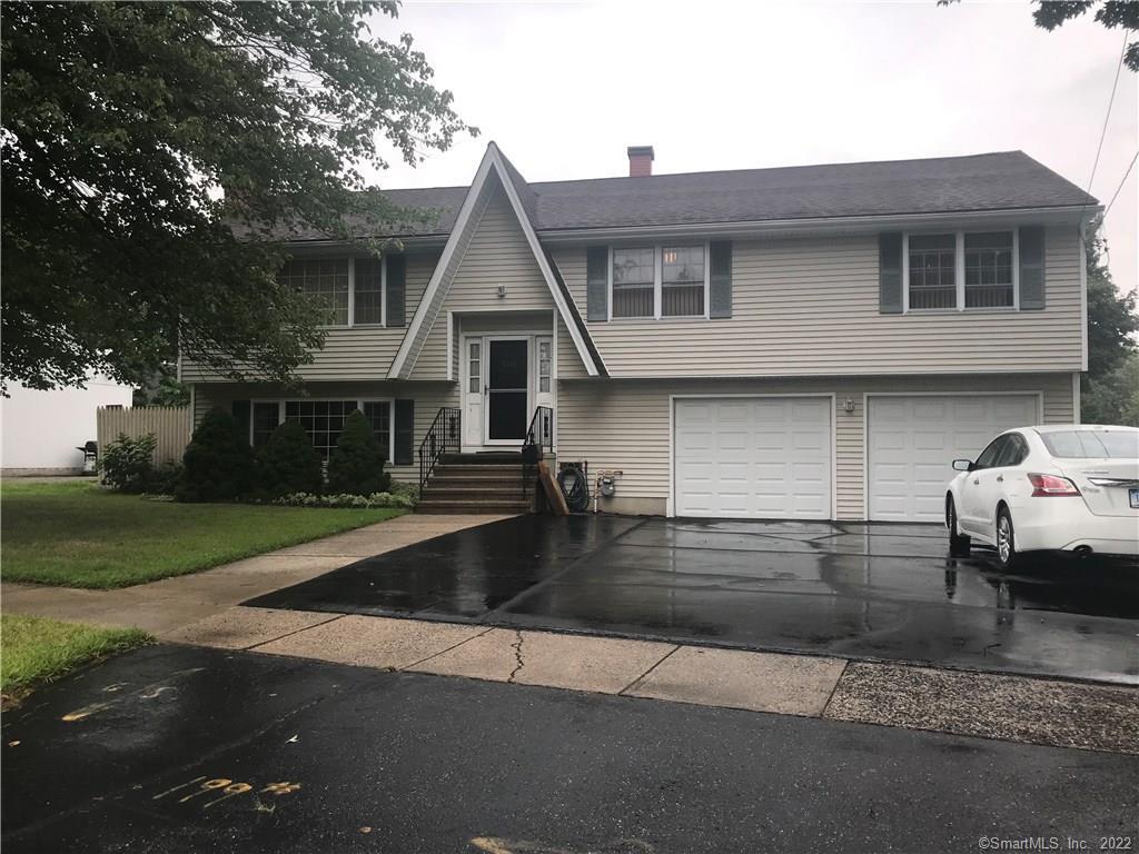 1082 Huntington Road Stratford, CT 06614 - Photo 1 of 1 a front view of a house with a yard and garage