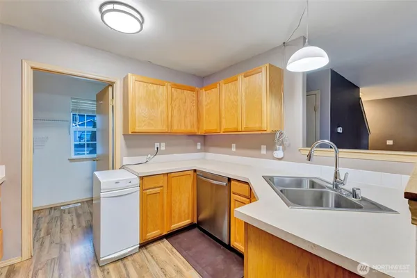 a kitchen with a sink cabinets and window
