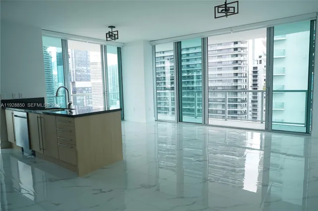 a view of kitchen with granite countertop cabinets and outdoor view
