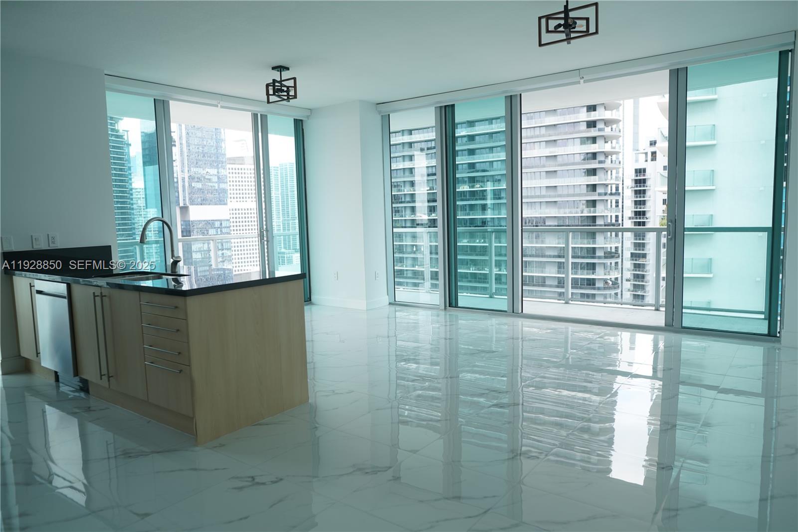 a view of kitchen with granite countertop cabinets and outdoor view