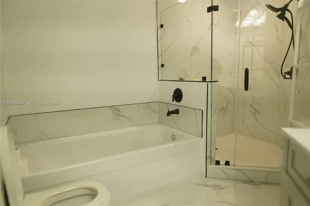 a bathroom with a shower and a bathtub