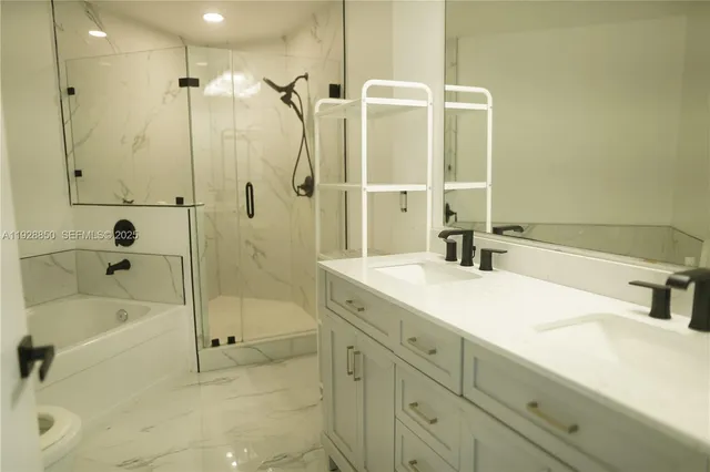 a bathroom with a tub sink shower and mirror