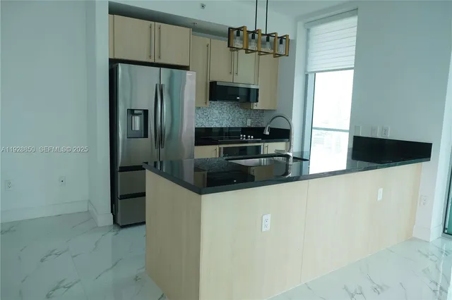 a kitchen with stainless steel appliances a refrigerator a stove a sink and dishwasher