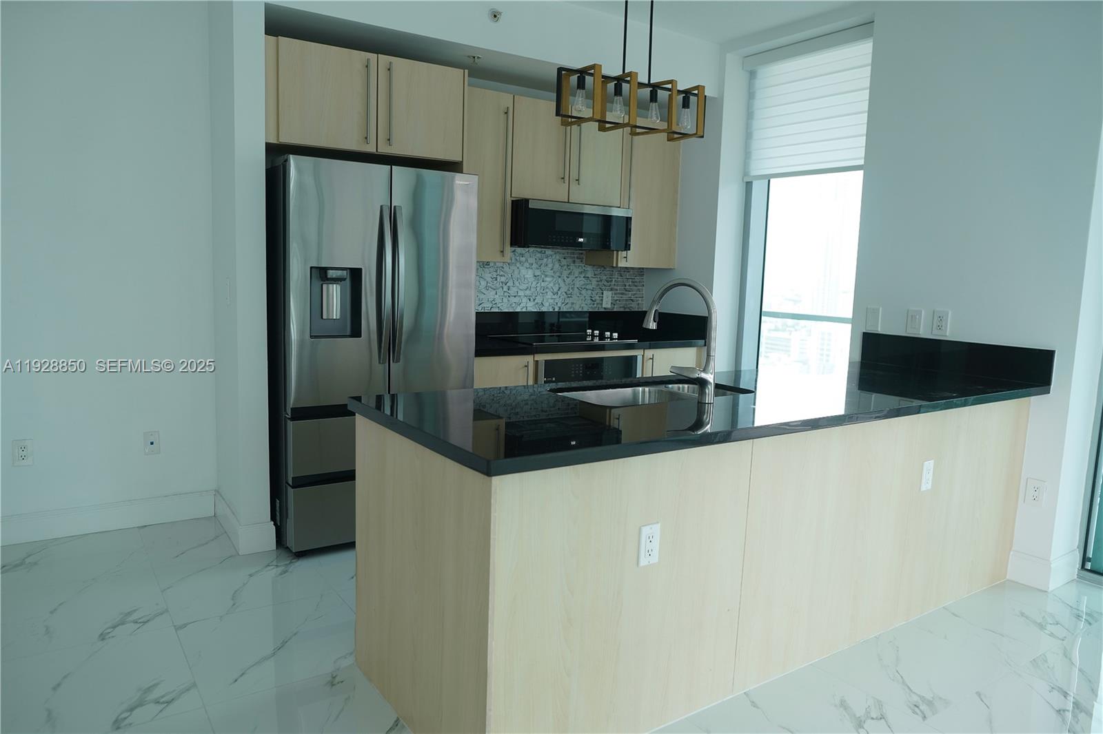 1111 Southwest 1st Avenue, Unit 3320N Miami, FL 33130 - Photo 3 of 20 a kitchen with stainless steel appliances a refrigerator a stove a sink and dishwasher