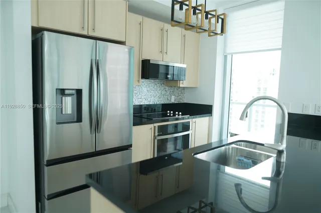 a kitchen with a refrigerator sink and stove