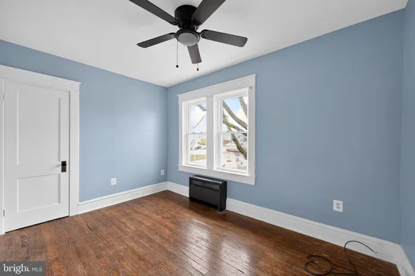 wooden floor in an empty room with a window