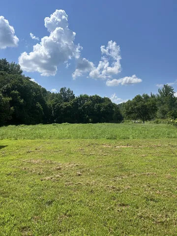 a view of a lake with a yard