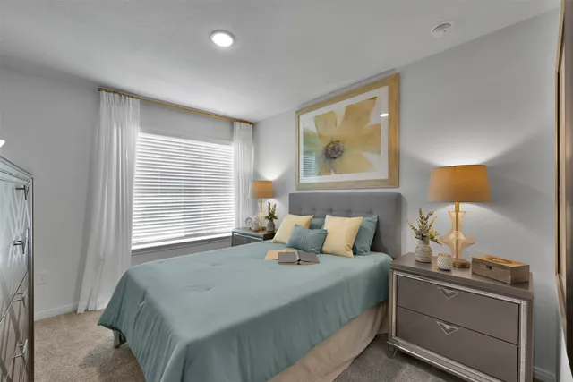 a bedroom with a bed and a lamp on table