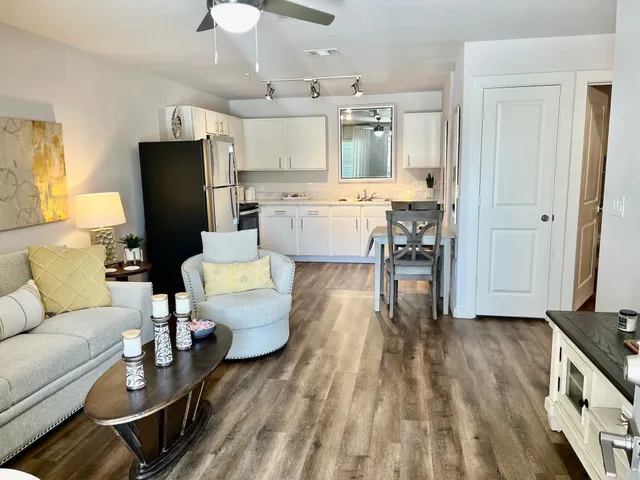 a living room with furniture and kitchen view