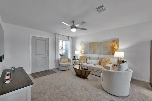 a living room with furniture and a large window