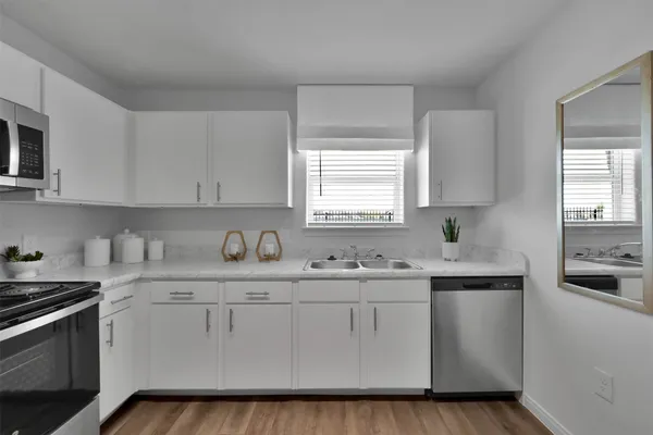 a kitchen with stainless steel appliances granite countertop a sink stove and cabinets