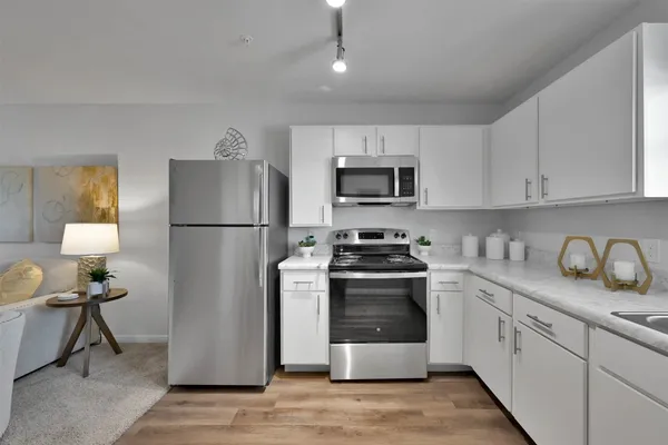 a kitchen with stainless steel appliances granite countertop a refrigerator stove a sink and a granite counter tops