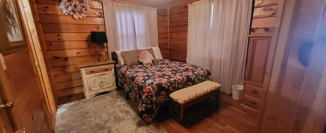 a bedroom with a bed and a window