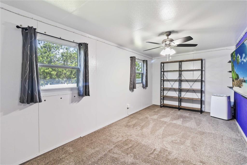 3723 Ricky Lane St. Cloud, FL 34772 - Photo 13 of 36 wooden floor in an empty room with a window