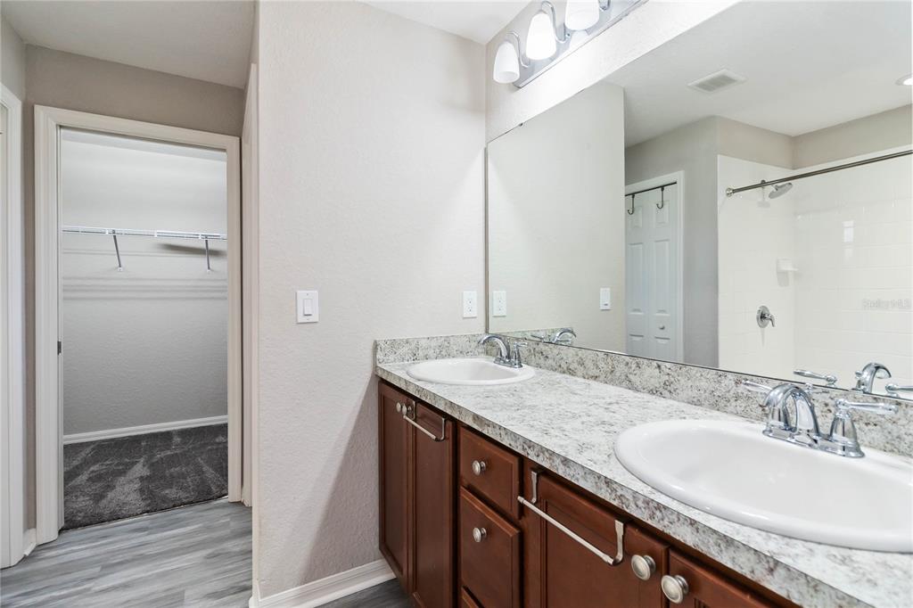 3723 Ricky Lane St. Cloud, FL 34772 - Photo 18 of 36 a bathroom with a granite countertop sink and a mirror
