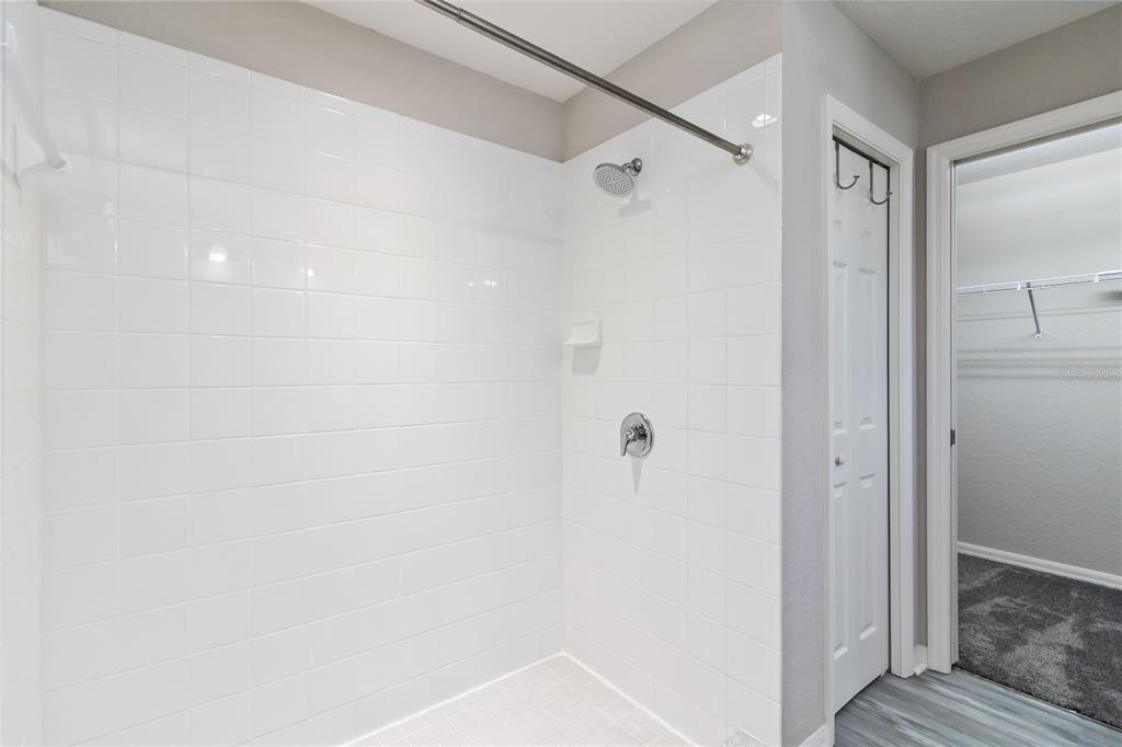 3723 Ricky Lane St. Cloud, FL 34772 - Photo 19 of 36 a bathroom with a shower and a glass door