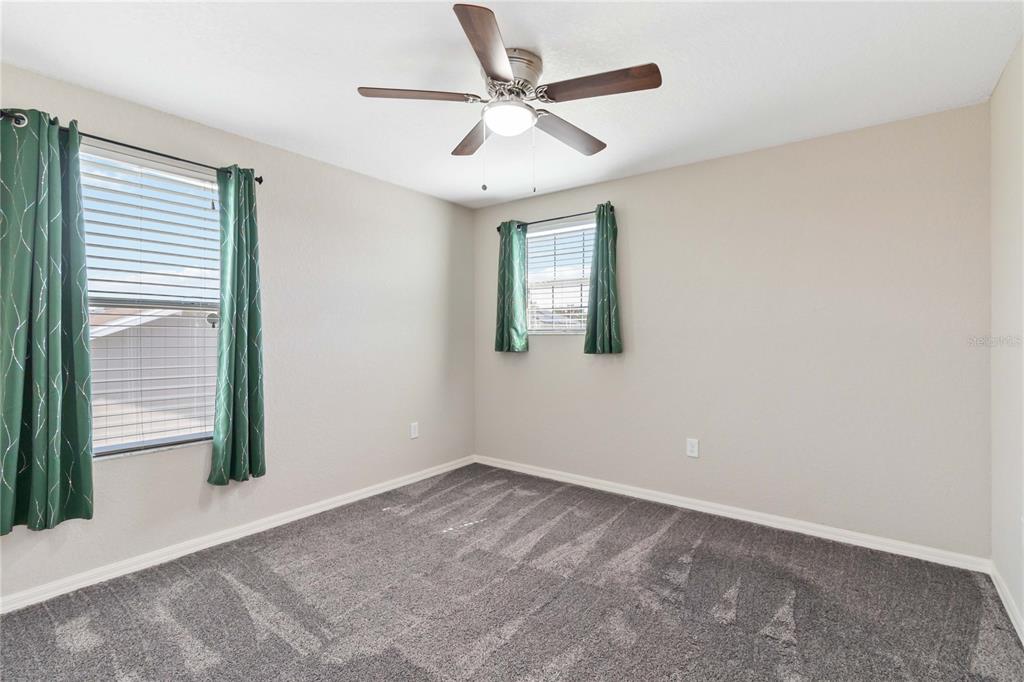 3723 Ricky Lane St. Cloud, FL 34772 - Photo 27 of 36 an empty room with windows and fan