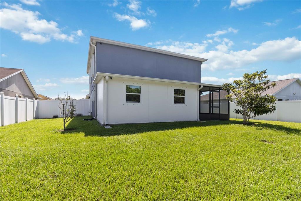 3723 Ricky Lane St. Cloud, FL 34772 - Photo 33 of 36 a backyard of a house with yard and outdoor seating