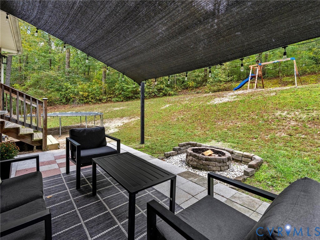 26315 Hill Road Ruther Glen, VA 22546 - Photo 44 of 47 View of patio featuring a trampoline, a playground