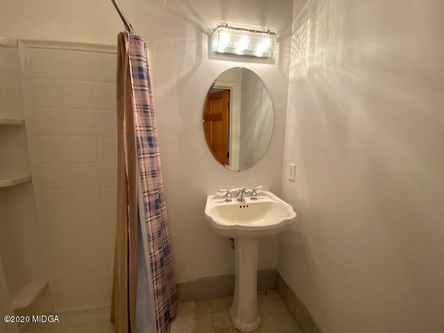 4999 Sandy Run Road Sparta, GA 31087 - Photo 13 of 19 a bathroom with a sink toilet and a mirror