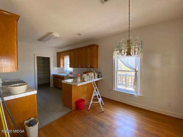4999 Sandy Run Road Sparta, GA 31087 - Photo 14 of 19 a bed room with furniture and a chandelier