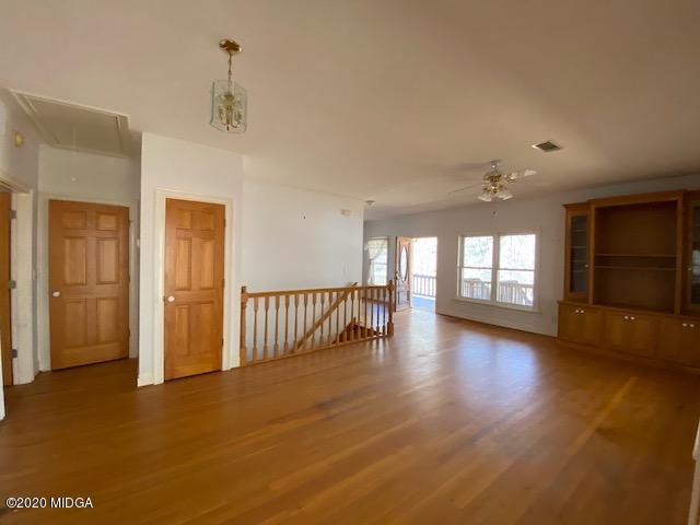 4999 Sandy Run Road Sparta, GA 31087 - Photo 10 of 19 a view of an empty room with window and wooden floor