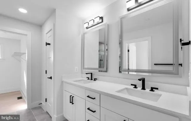 a bathroom with a double vanity sink mirror and double