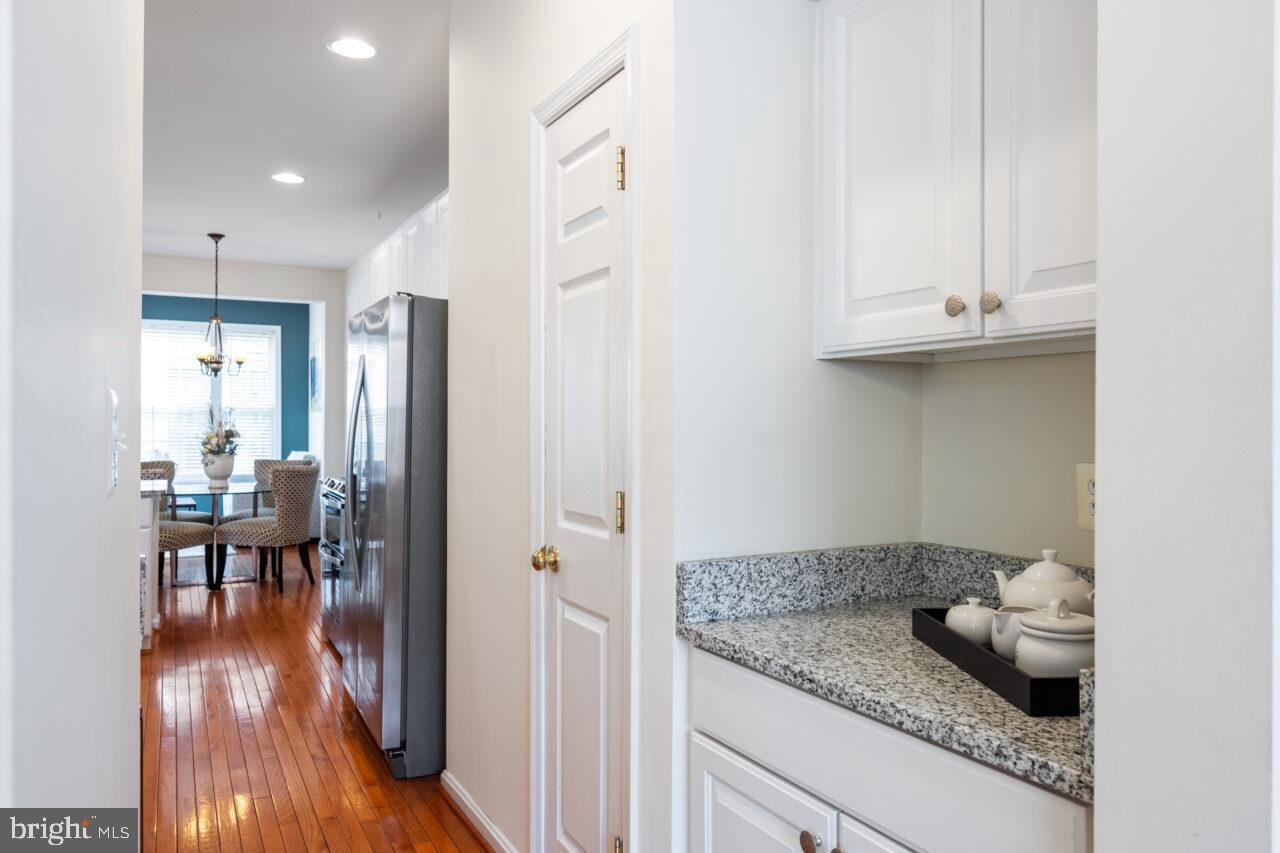 47799 Scotsborough Square Sterling, VA 20165 - Photo 12 of 53 a kitchen with granite countertop a table and chairs in it