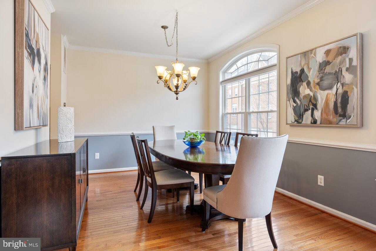 47799 Scotsborough Square Sterling, VA 20165 - Photo 14 of 53 a view of a dining room with furniture a chandelier and wooden floor