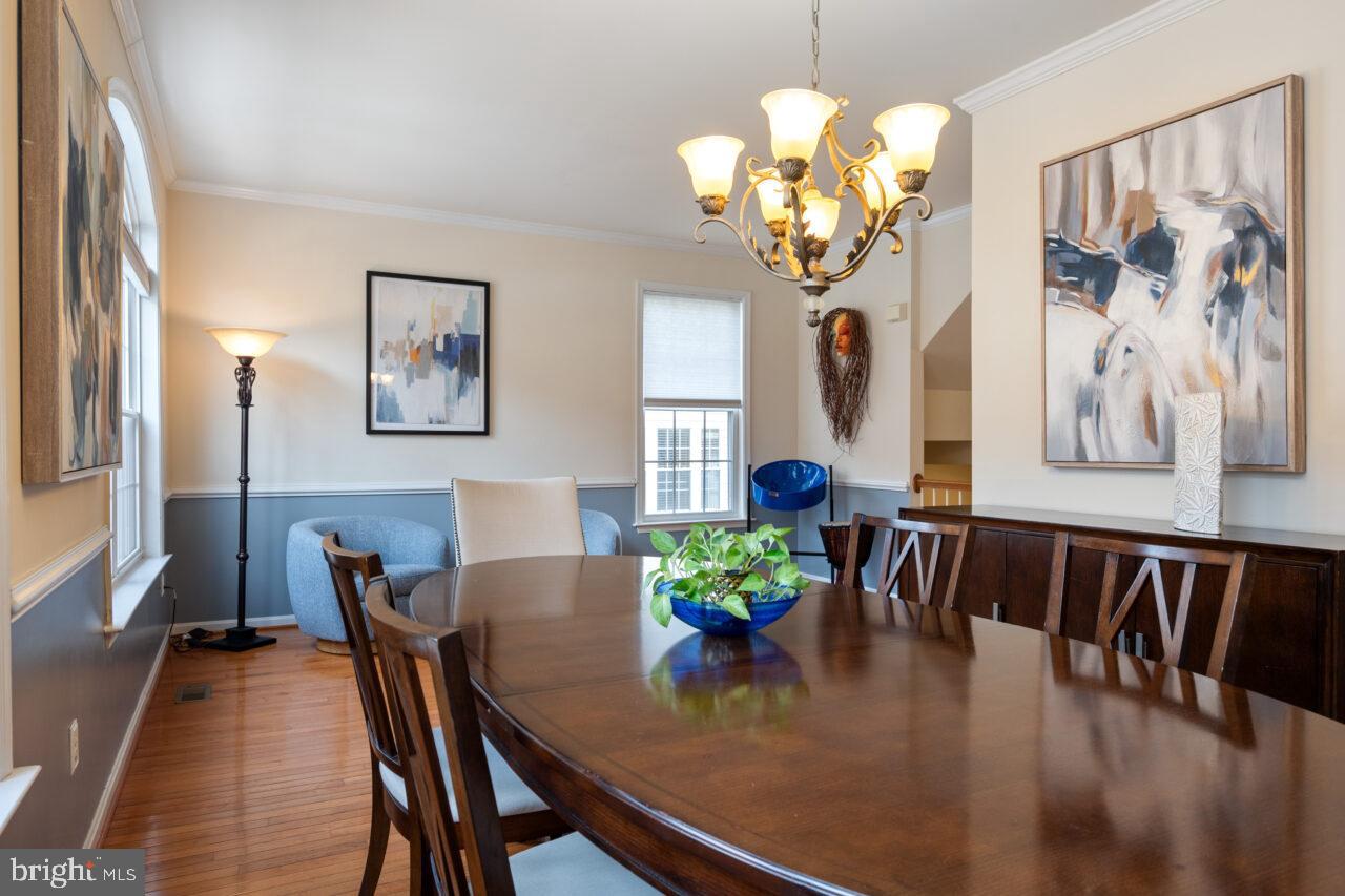 47799 Scotsborough Square Sterling, VA 20165 - Photo 15 of 53 a view of a dining room with furniture and chandelier