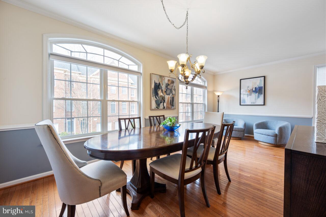 47799 Scotsborough Square Sterling, VA 20165 - Photo 16 of 53 a view of a dining room with furniture a chandelier and wooden floor