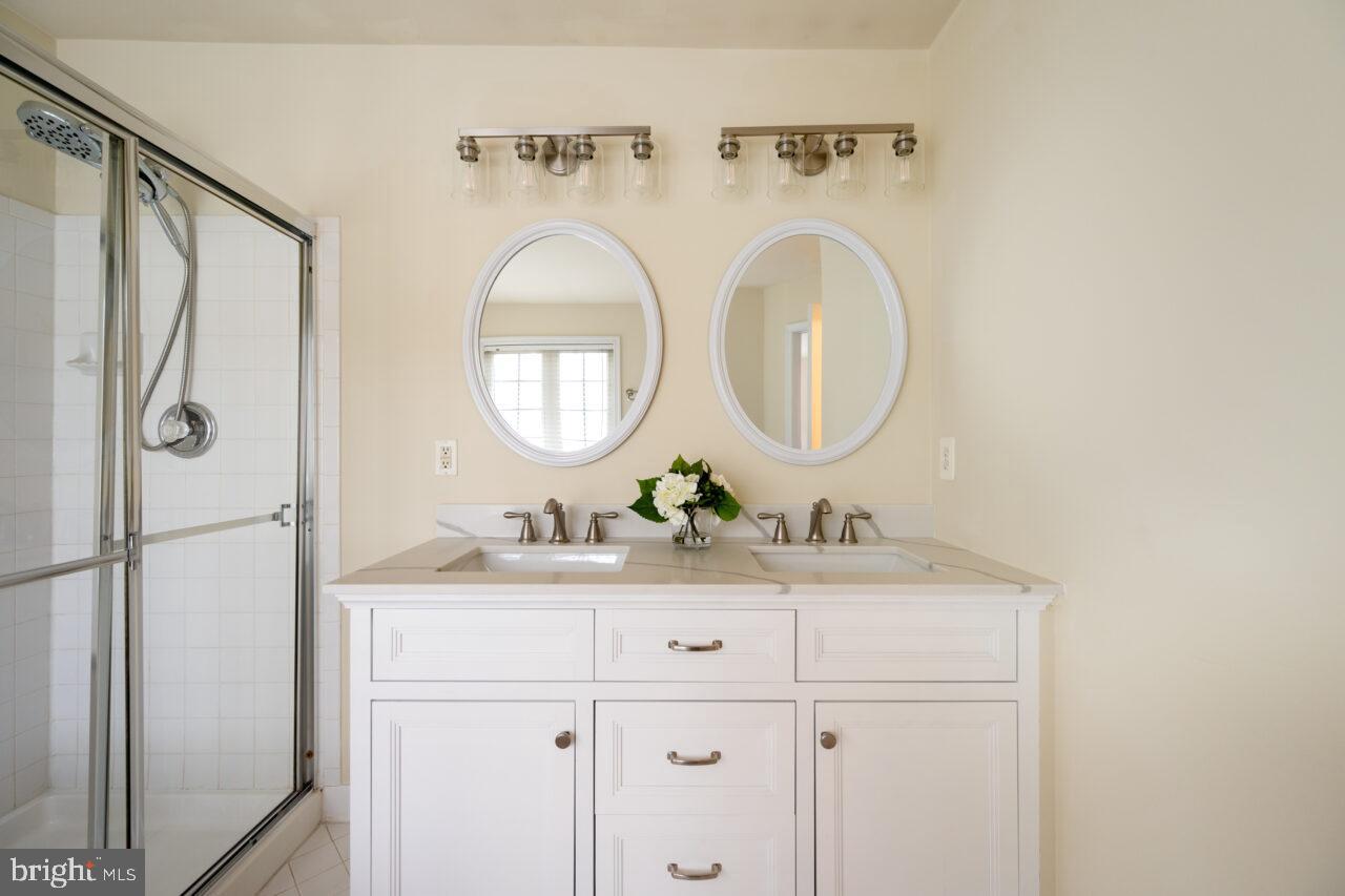 47799 Scotsborough Square Sterling, VA 20165 - Photo 29 of 53 a bathroom with a sink and a mirror
