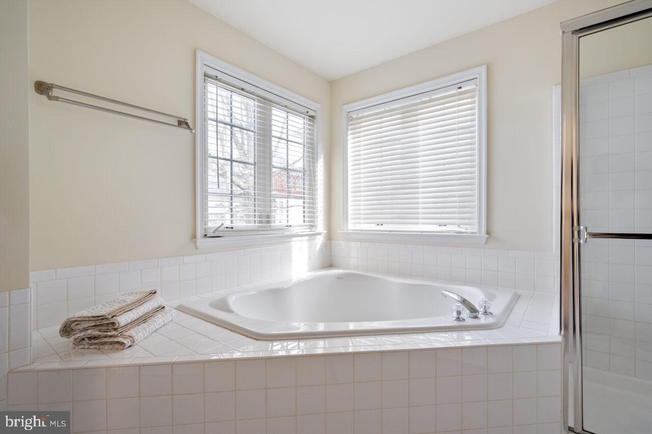 47799 Scotsborough Square Sterling, VA 20165 - Photo 30 of 53 a white bath tub sitting in a bathroom next to a window