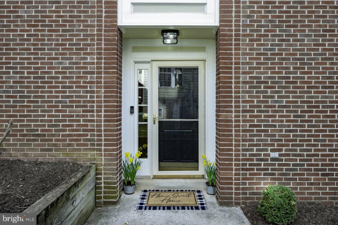 47799 Scotsborough Square Sterling, VA 20165 - Photo 3 of 53 a front view of a building with a garden