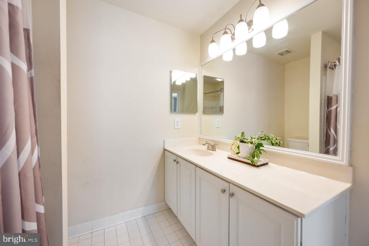 47799 Scotsborough Square Sterling, VA 20165 - Photo 34 of 53 a bathroom with a sink a vanity and a mirror