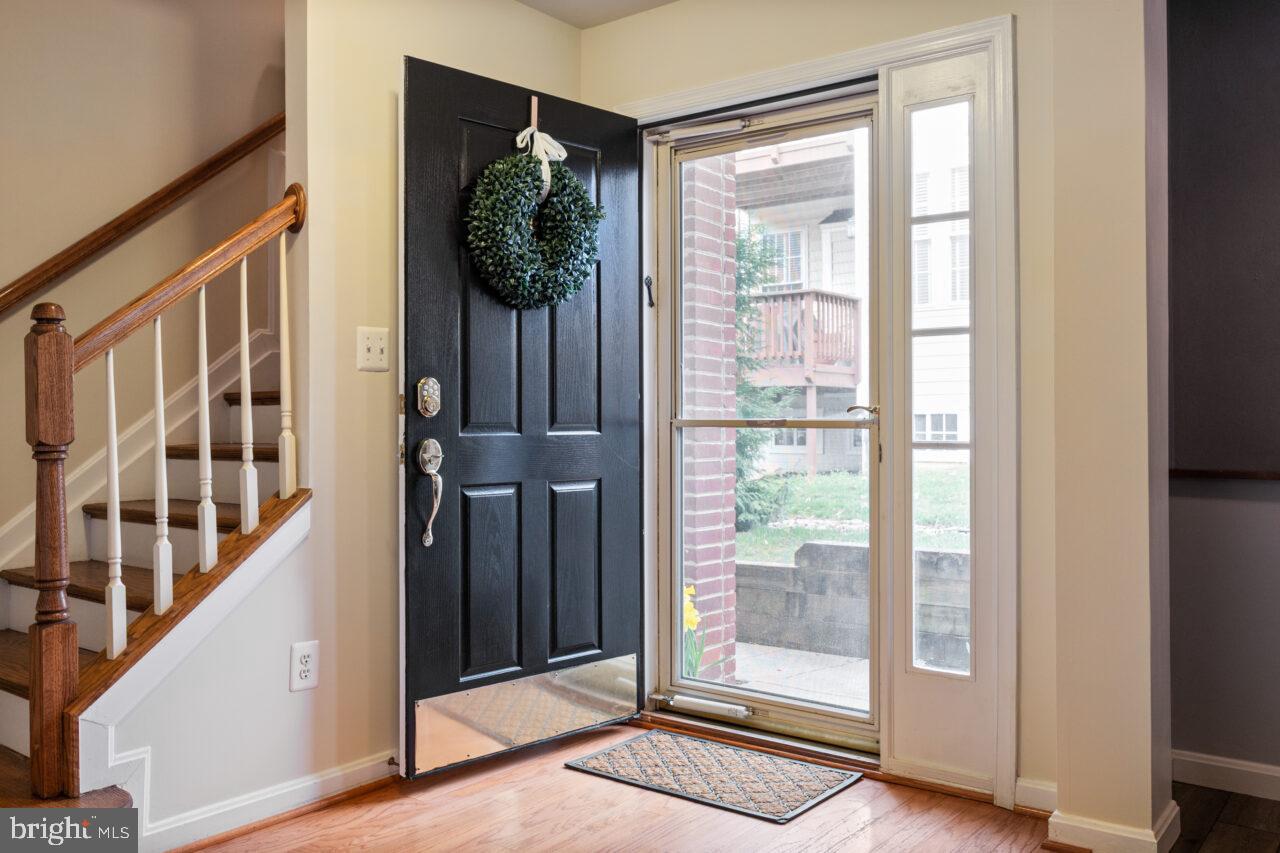 47799 Scotsborough Square Sterling, VA 20165 - Photo 4 of 53 a view of a hallway with wooden floor and windows