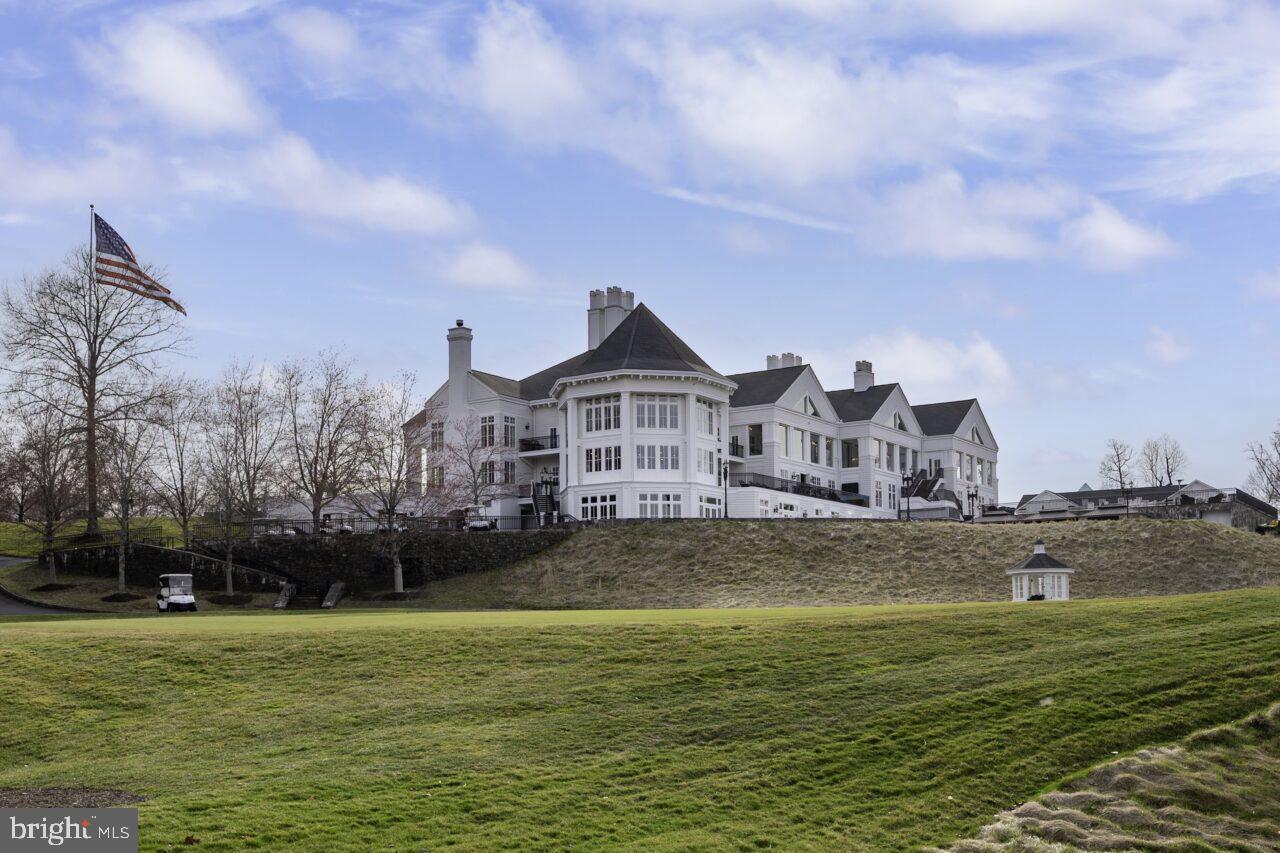 47799 Scotsborough Square Sterling, VA 20165 - Photo 49 of 53 a front view of a house with a garden and lake