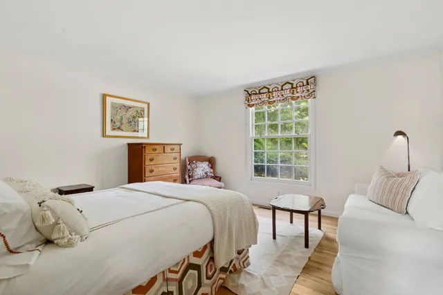 a bedroom with a bed and a window with outer view
